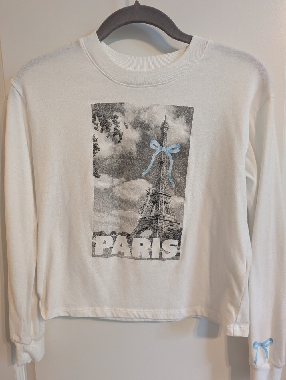 Abercrombie Kids Paris Graphic White Sweatshirt with Blue Bow Detail